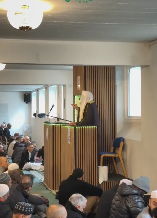 Imam giving the friday sermon to individuals in the mosque